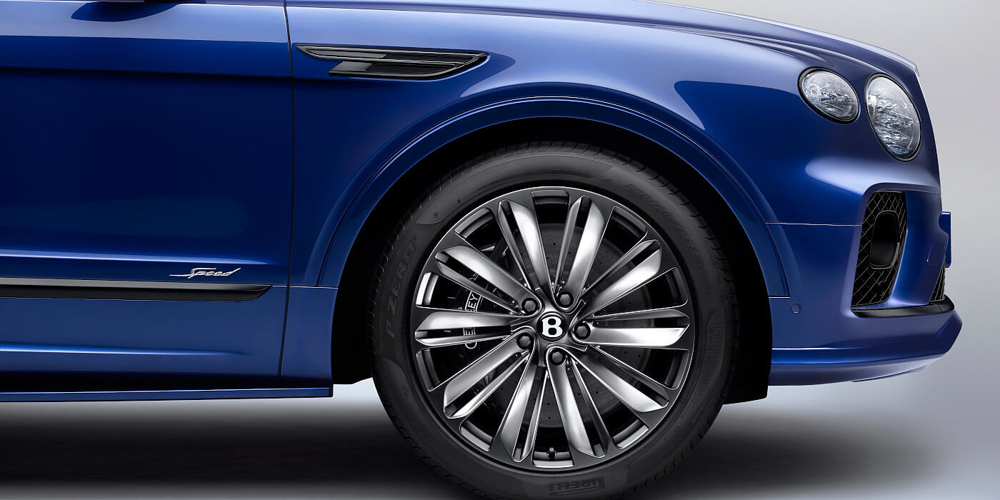 Bentley Brisbane Bentley Bentayga Speed SUV in Moroccan Blue paint with chrome badge and front wheel close up