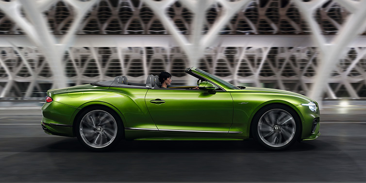 Bentley Brisbane Bentley Continental GTC Speed convertible side profile in Tourmaline Green paint driving dynamically on a bridge at night