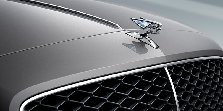 Bentley Brisbane New Bentley Flying Spur sedan bonnet detail in Silverlake paint with Illuminated Flying B bonnet badge and matrix grille with chrome surround