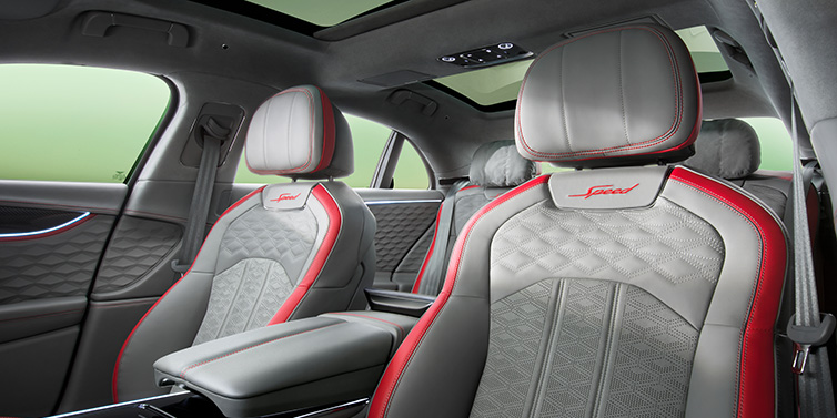 Bentley Brisbane Bentley Flying Spur Speed sedan interior showing front and rear seats in Hotspur red and Gravity Grey hides, with Speed seat emblems