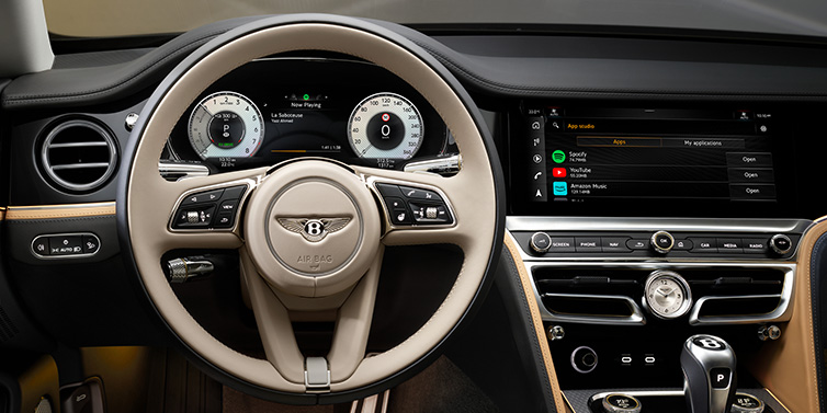 Bentley Brisbane Bentley Flying Spur Mulliner sedan front interior detail of steering wheel and driver screens surrounded by Linen and Beluga black hides