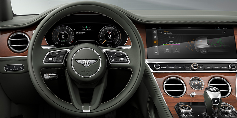 Bentley Brisbane New Bentley Continental GT coupe steering wheel and front cabin view in Cumbrian Green hide and Crown Cut walnut veneer