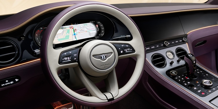 Bentley Brisbane Bentley Continental GT Mulliner coupe front interior showing steering wheel and drivers screens surrounded by Linen and Damson hides and Grand Black veneer